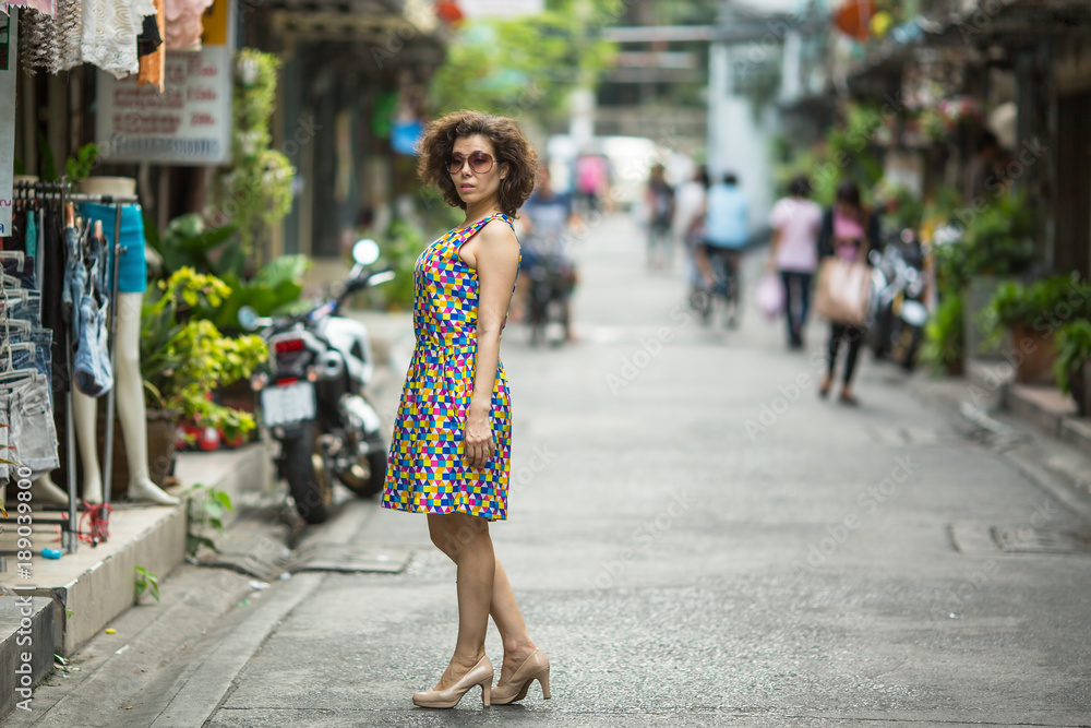 Young asian woman stands on the street. Young asian woman stands on the street.