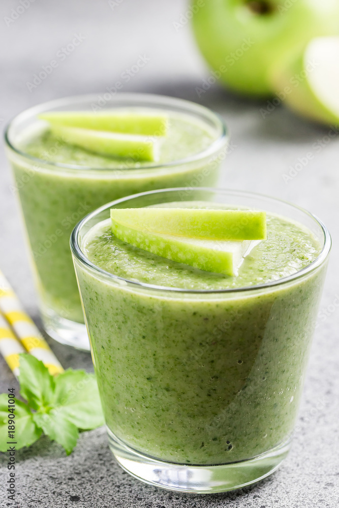 Fresh mint green apple smoothie on concrete background. Selective focus, space for text. Fresh mint green apple smoothie on concrete background. Selective focus, space for text.