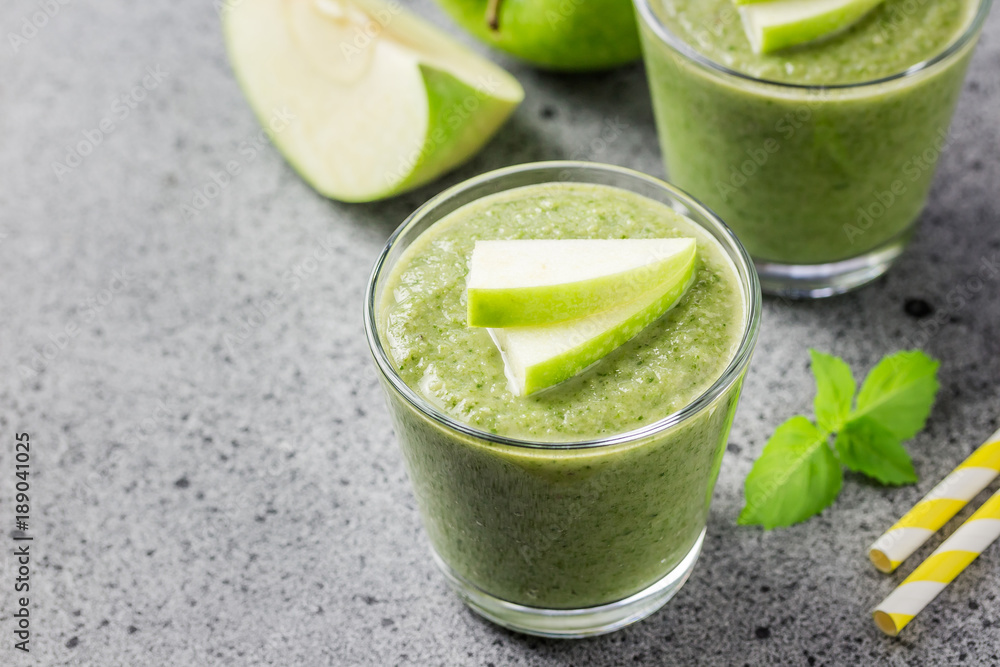 Detox matcha green apple banana smoothie on concrete background. Selective focus, space for text. Detox matcha green apple banana smoothie on concrete background. Selective focus, space for text.