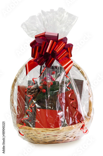 Obraz na płótnie gift basket packed in transparent paper with a big red bow isolated on a white b