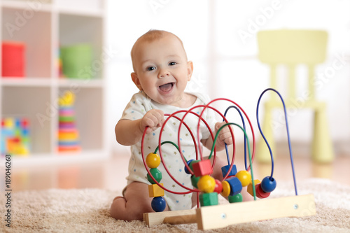 Adorable baby playing in nu...