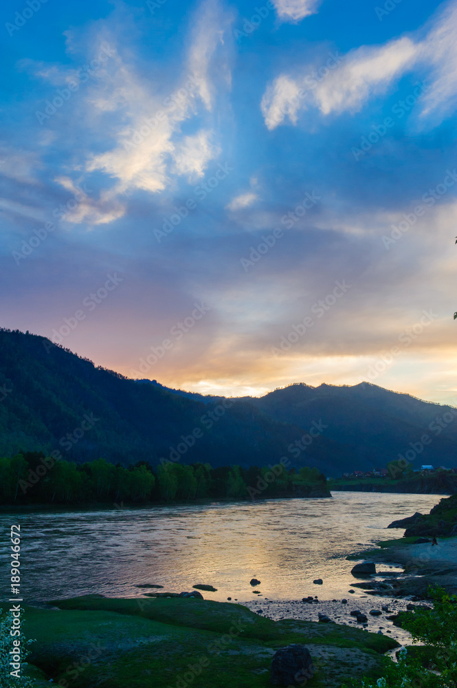 Picturesque sunset over mountain river and small village