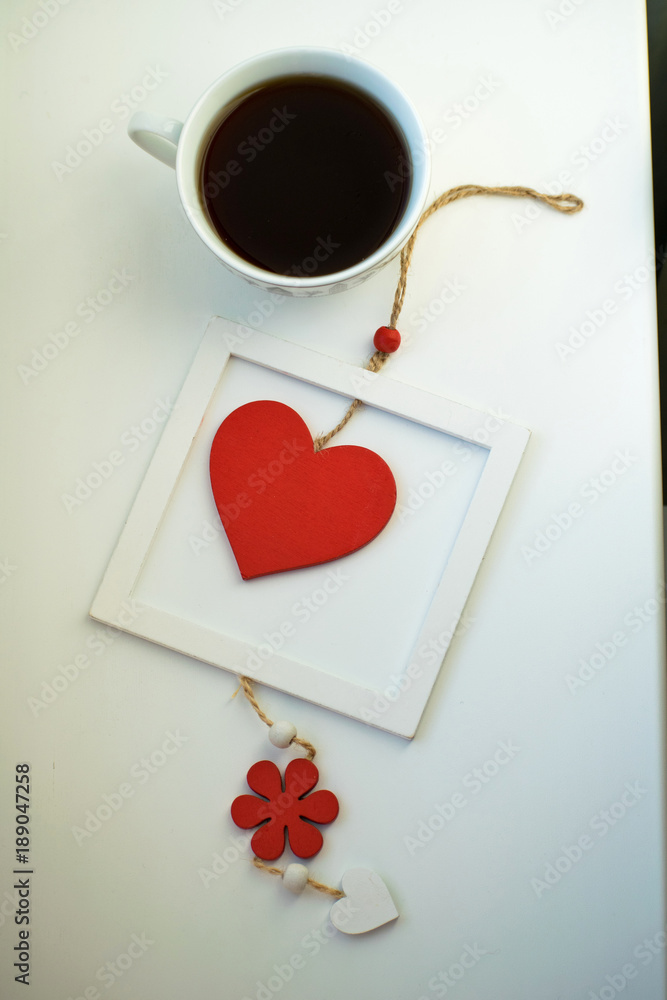 Cup of love, coffee with red heart. Red heart on a rope in the wooden frame. Valentine's day. Morning. The 14th of February.