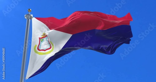 Flag of Sint Maarten waving at wind in slow with blue sky, loop photo