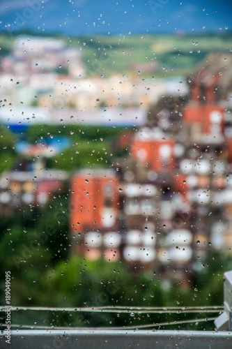 A view of the building through a rainy window