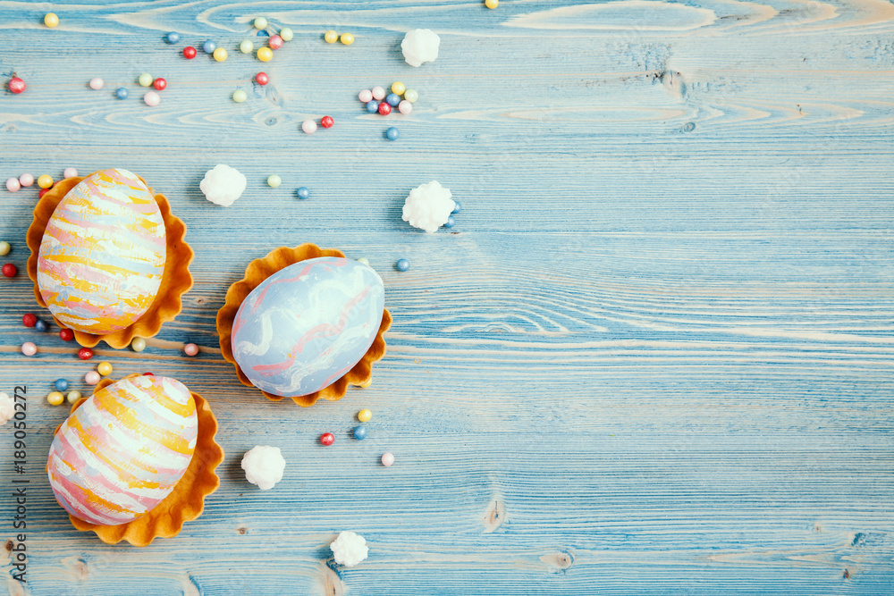Easter multicolored eggs on a blue wooden background. Background for a postcard, Easter concept, space for text. Easter multicolored eggs on a blue wooden background. Background for a postcard, Easter concept, space for text.