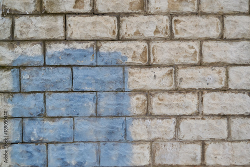 old white brick walls with blue spot