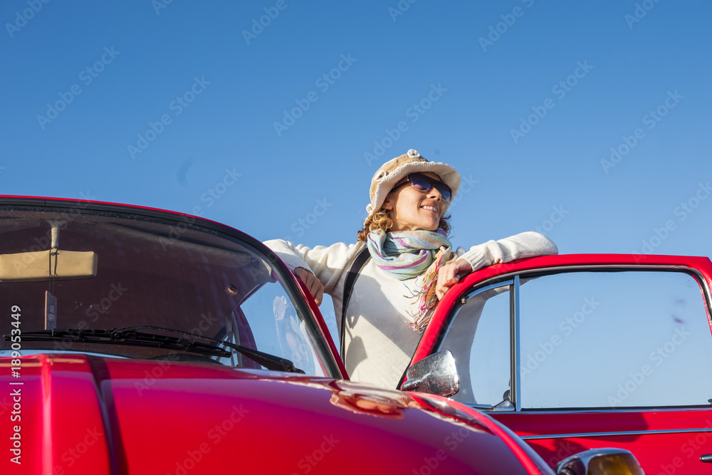 beautiful hippy vintage woman with old red car