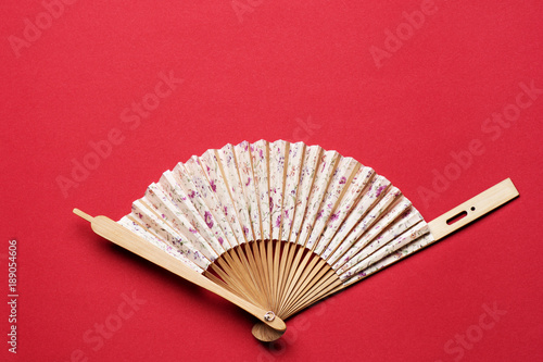 Korean folding fan on red background photo