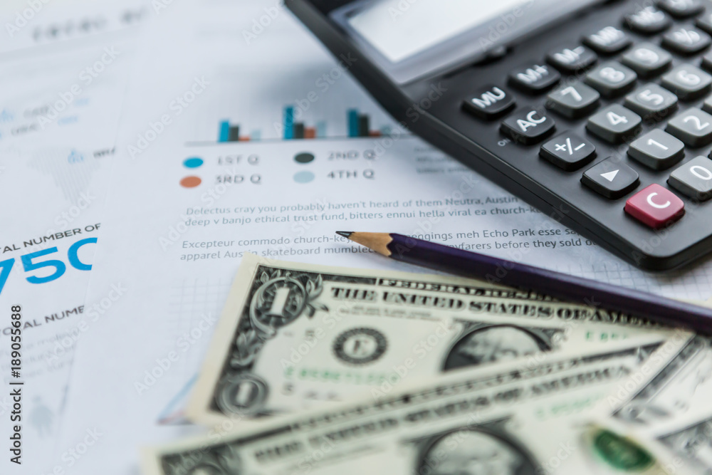 Calculator with american dollars on the wooden table background, finance concept Calculator with american dollars on the wooden table background, finance concept