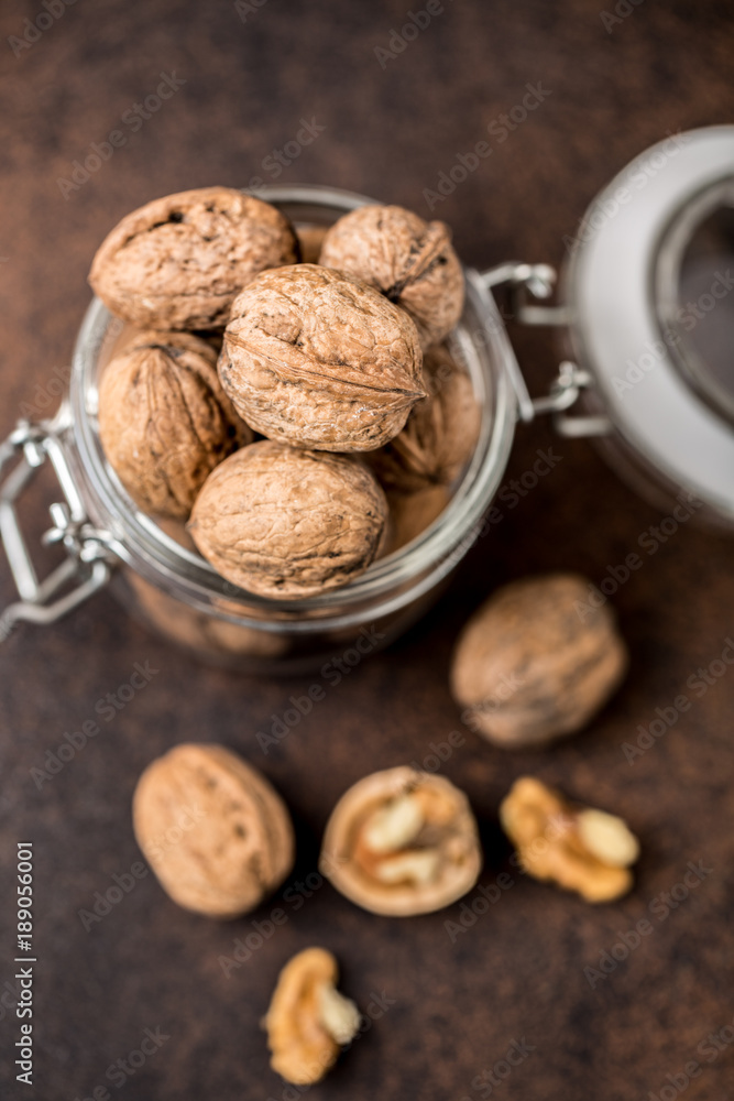 Walnuts. Walnut kernels and whole walnuts on rustic table. Walnuts. Walnut kernels and whole walnuts on rustic table.