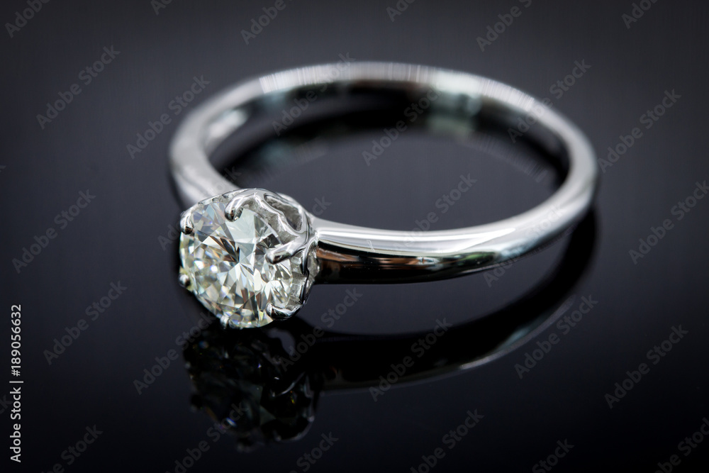 Diamond ring for wedding and engagement on gradient black background Diamond ring for wedding and engagement on gradient black background