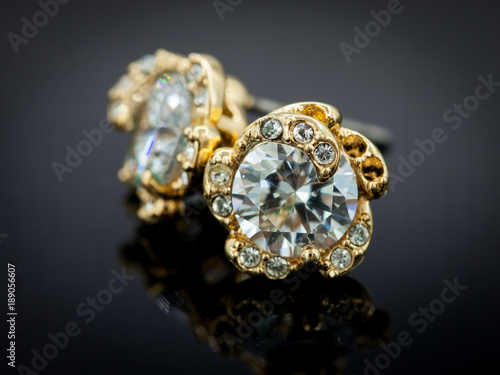 Diamond earring on gradient black background