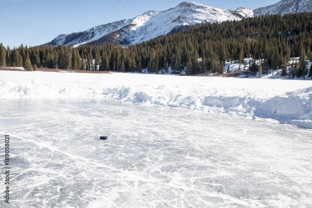 Puck on a small rink - Pond hockey on Andrew's lake in Colorado near Silverton