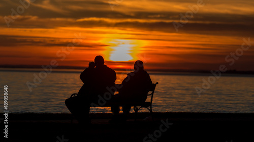 People silhouette on the sunset light near the lake Balaton in Hungary © Arpad