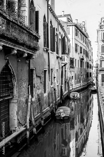 Narrow, ancient and romantic venetian canals. Venice, Italy. Black and white image. © Victoria
