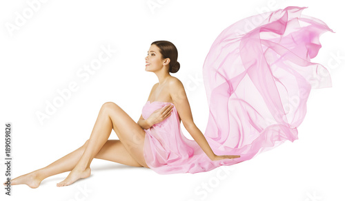 Woman Body Beauty Care, Sexy Model in Pink Flying Flowing Dress Cloth Sitting over White Background