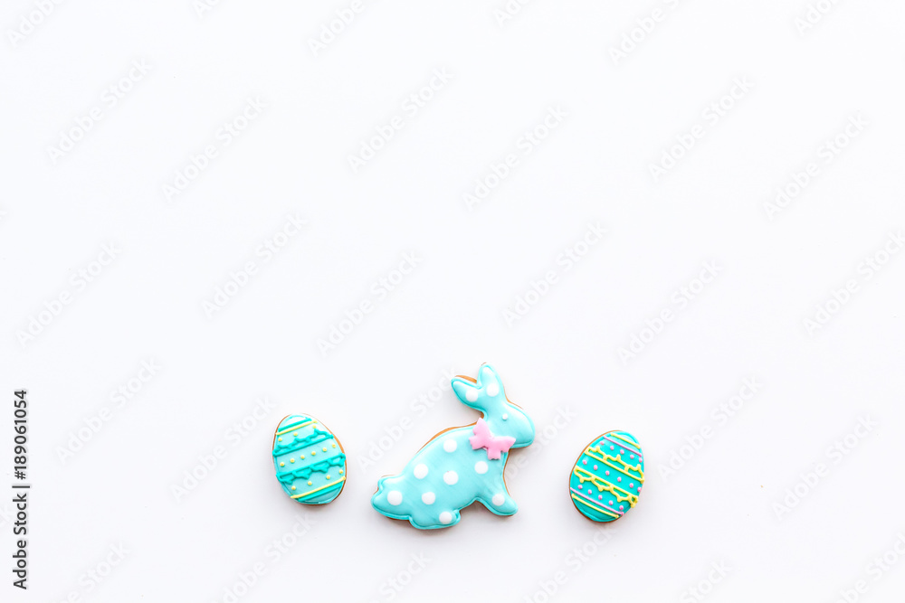 Easter background. Cookies in shape of easter bunny and easter eggs. White background top view space for text
