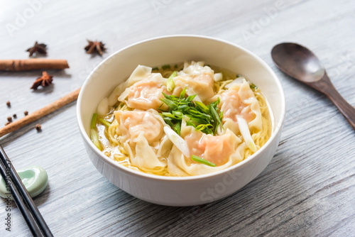 Shrimp wonton with braised pork in soup on wooden table - Asian food style, Select focus image