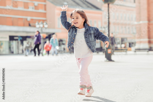 Portrait of happy child playing outdoors.
