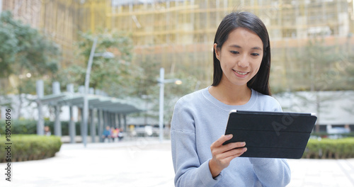 Free Download Woman use of digital tablet computer at outdoor - GFXLoad