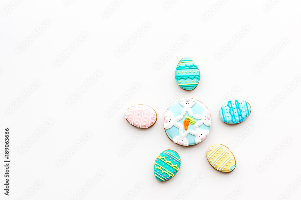 Sweets for celebrate Easter. Gingerbread in shape of easter eggs. White background top view copy space Sweets for celebrate Easter. Gingerbread in shape of easter eggs. White background top view copy space