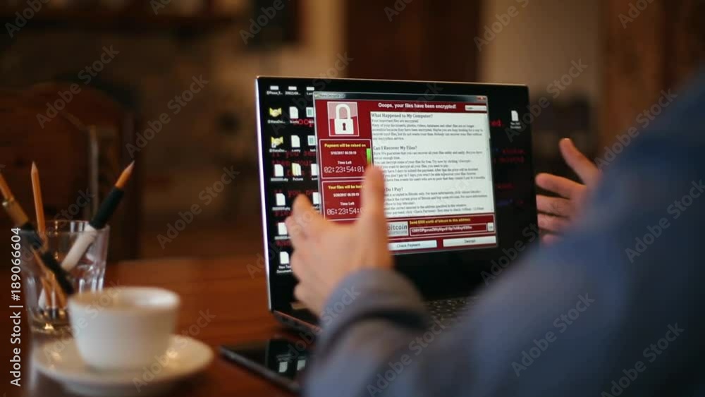 Man turns on a laptop waits for loading computer and finds out it is infected by a ransomware spyware virus that is asking for money to retrieve the encrypted files. Tracking and revealing shot