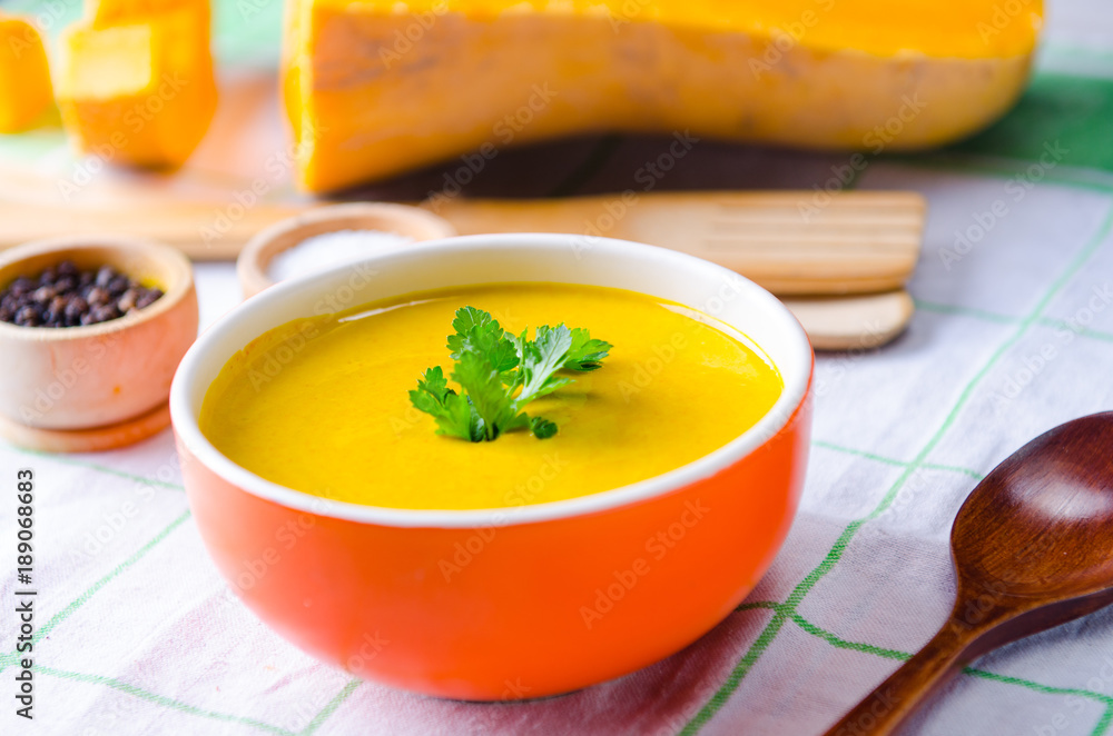 Pumpkin soup served on the table in bowl Pumpkin soup served on the table in bowl