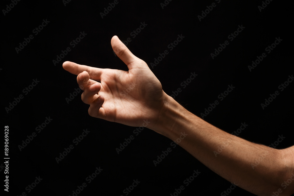 Male hand holding virtual smartphone isolated on black Male hand holding virtual smartphone isolated on black