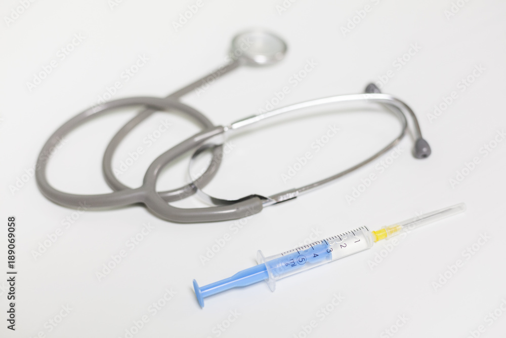Medical essential - syringe and stethoscope Medical essential - syringe and stethoscope