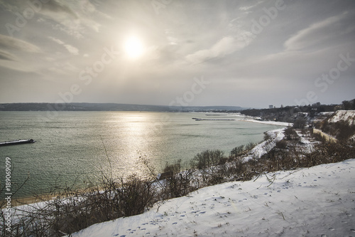Landscape of the bay of Varna  with snow at sunset.