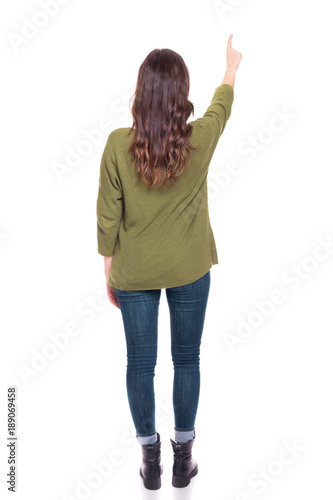 Back view of a young girl pointing, isolated on a white background