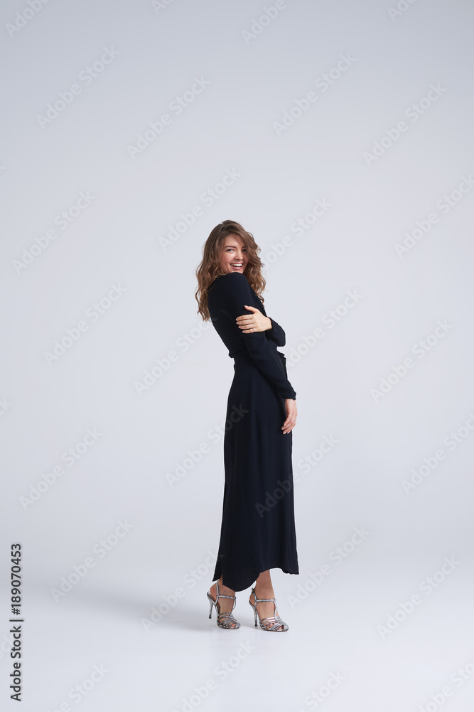 Sensual brunette in black dress looking over shoulder Sensual brunette in black dress looking over shoulder