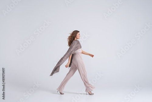 Woman wearing trend clothing and silk scarf walking