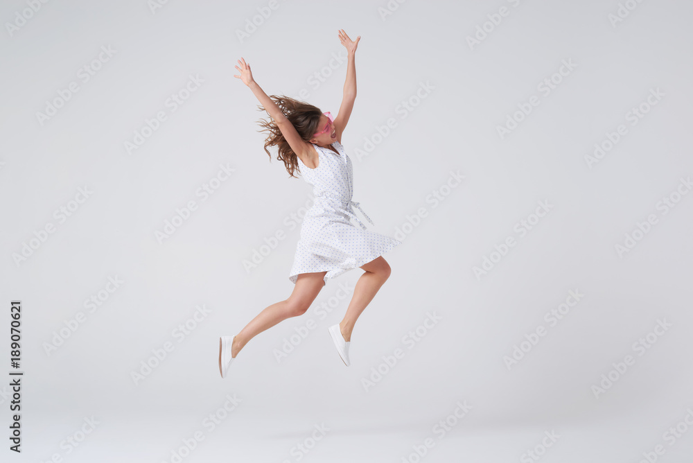 Cheerful beautiful young woman jumping
