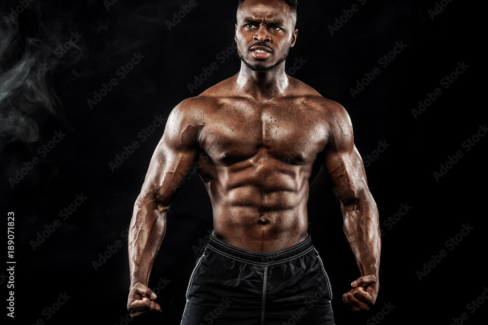 Muscular young fitness sports man workout with dumbbell in fitness gym Muscular young fitness sports man workout with dumbbell in fitness gym