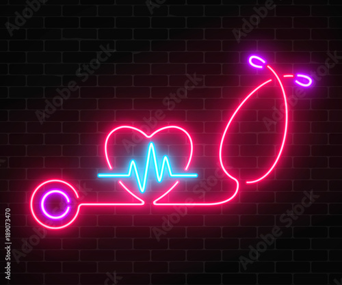 Glowing neon medicine concept sign with cardiogram graph in heart shape and stethoscope on a brick wall background.