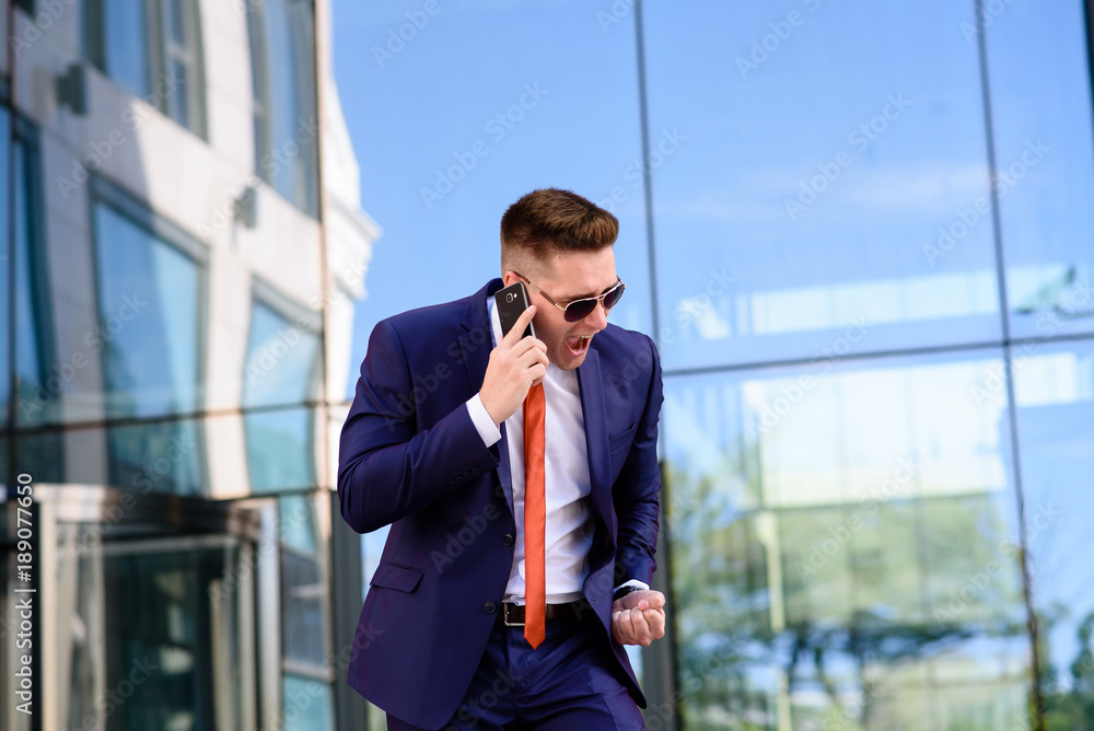 Businessman talking on the phone and smiling. Businessman talking on the phone and smiling.
