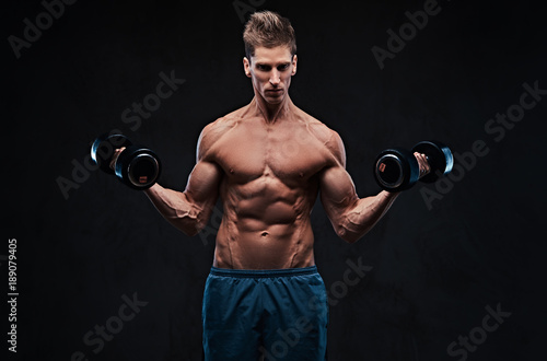 Athletic shirtless male biceps dumbbell workout. © Fxquadro