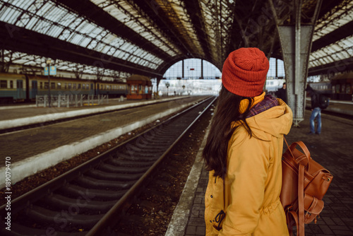 woman wiating for train on railway station photo
