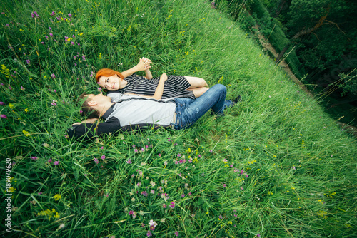 couple lie on the grass