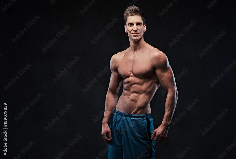 Fototapeta premium Shirtless muscular male over dark background.