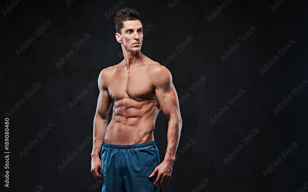 Fototapeta premium Shirtless muscular male over dark background.