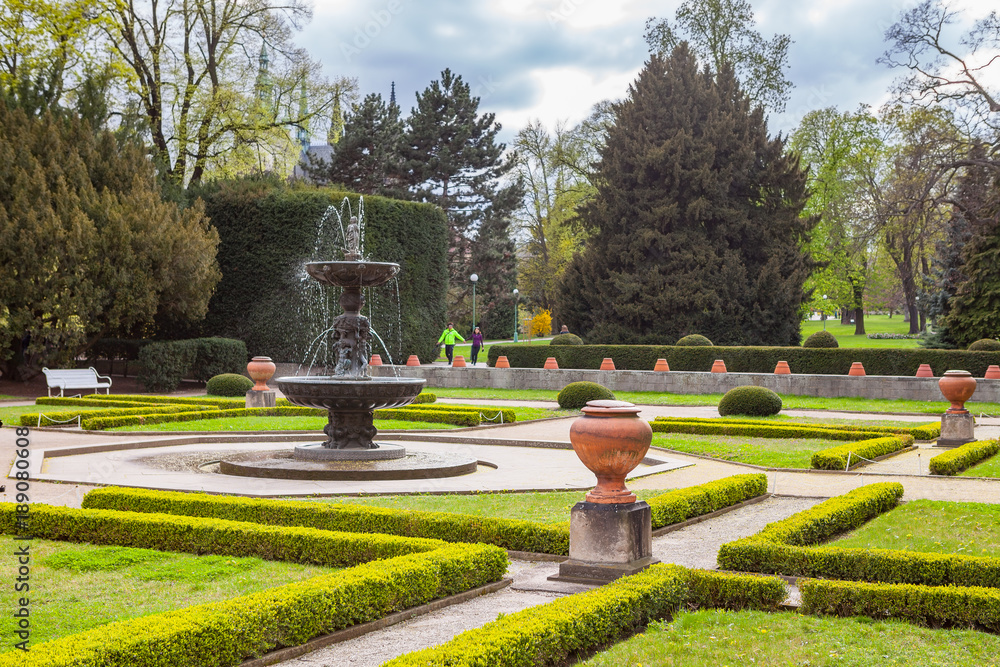 Fototapeta premium PRAGUE, CZECH REPUBLIC - APRIL, 25, 2017: The Singing Fountain in Kralovska Zahrada the Royal Gardens park in Hradcany. Luxury park style.