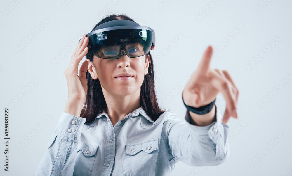 Woman wearing augmented reality goggles. Woman wearing augmented reality goggles.
