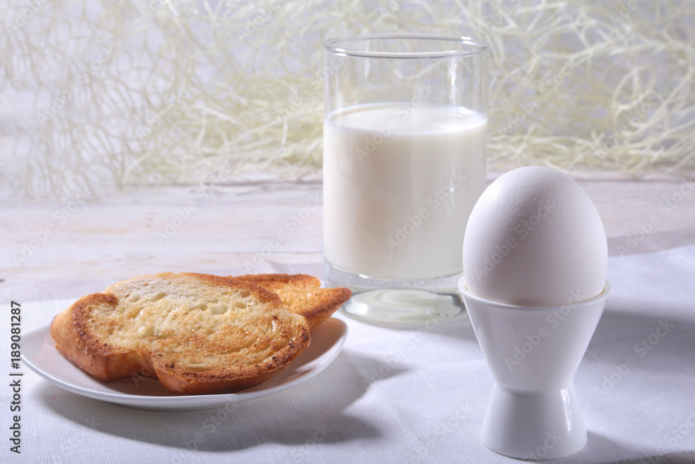 Morning Breakfast set with egg, orange jam on bread toast and milk in glass. Morning Breakfast set with egg, orange jam on bread toast and milk in glass.
