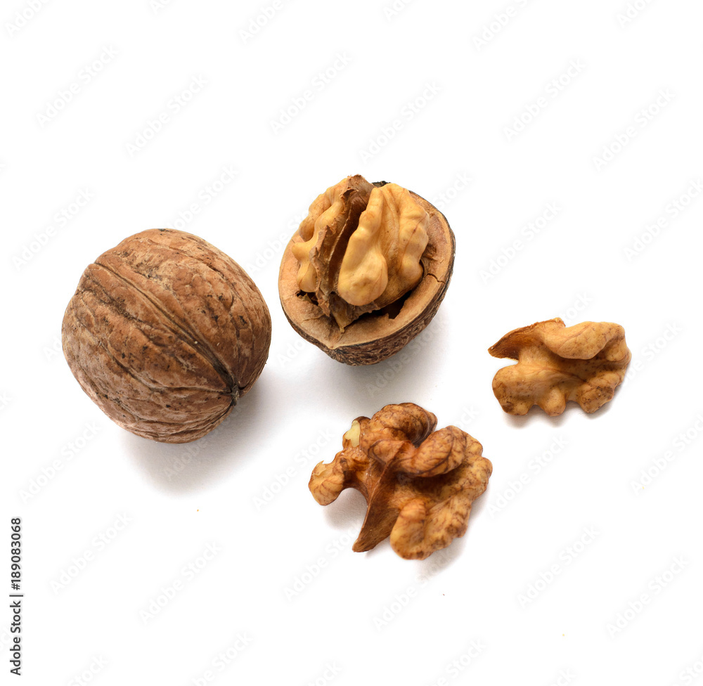 Whole walnuts in shell and chopped walnuts isolated on white background. A few nuts. Healthy foods Whole walnuts in shell and chopped walnuts isolated on white background. A few nuts. Healthy foods