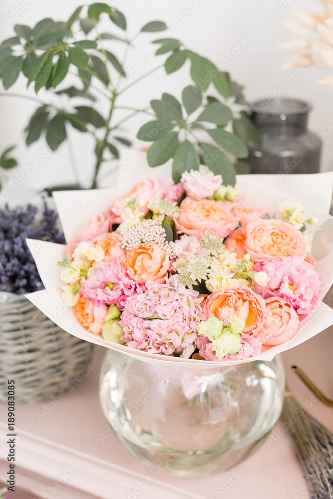 Few of beautiful luxury bouquet. Mixed flowers on pink table. the work of the florist at a flower shop. Wedding