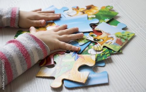 hands collect puzzle on the table, the concept of lifestyle