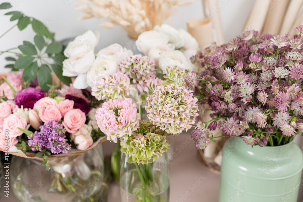Few of beautiful luxury bouquet. Mixed flowers on pink table. the work of the florist at a flower shop. Wedding Few of beautiful luxury bouquet. Mixed flowers on pink table. the work of the florist at a flower shop. Wedding